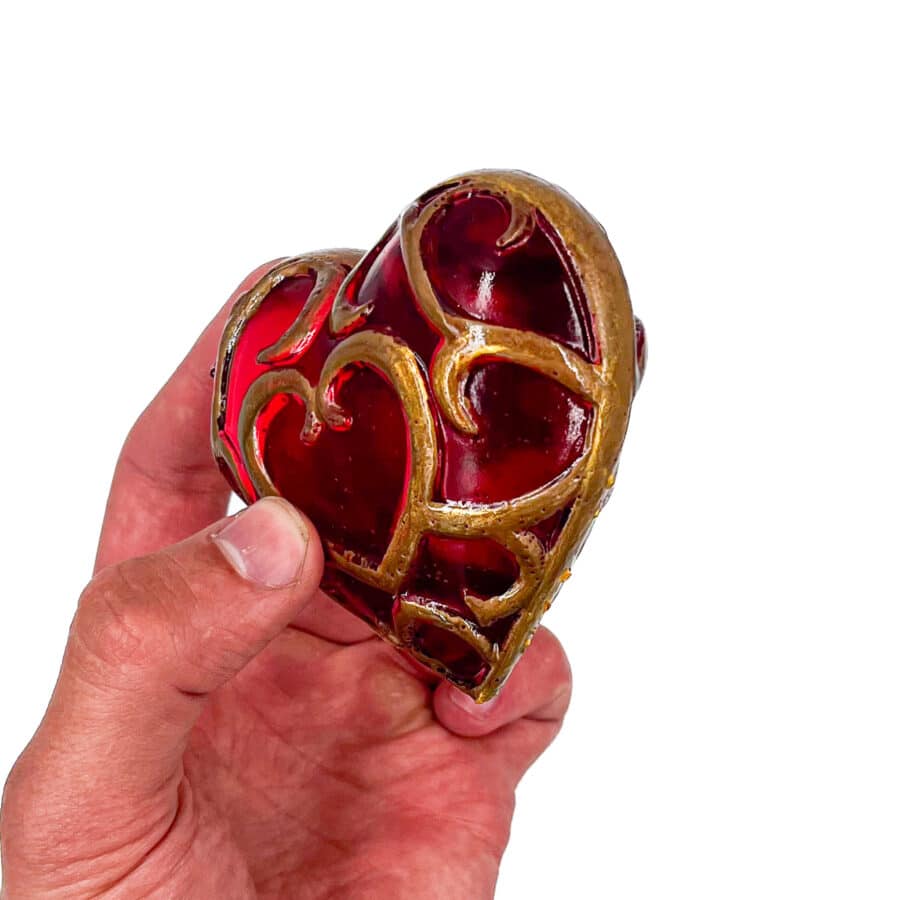 "Handcrafted Legend of Zelda Heart Container - vibrant red resin with gold accents.